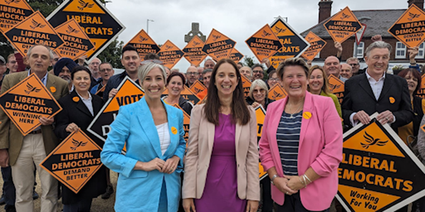 Emma Holland-Lindsay with Daisy Cooper MP and Sarah Dyke MP, plus Lib Dem supporters.