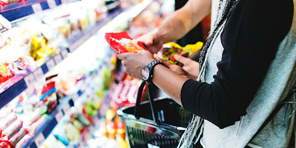 A customer checks an item before putting it in their basket.