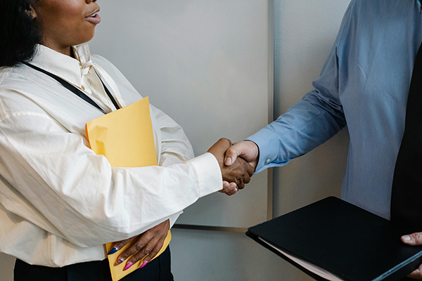 Two people shake hands