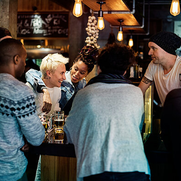 Groups of friends socialising in a pub.