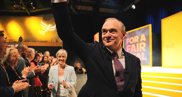 Ed Davey MP waves to the crowd in the Conference auditorium.