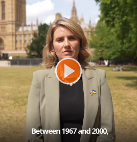 Jess Brown-Fuller MP stands outside the Houses of Parliament addressing the camera directly
