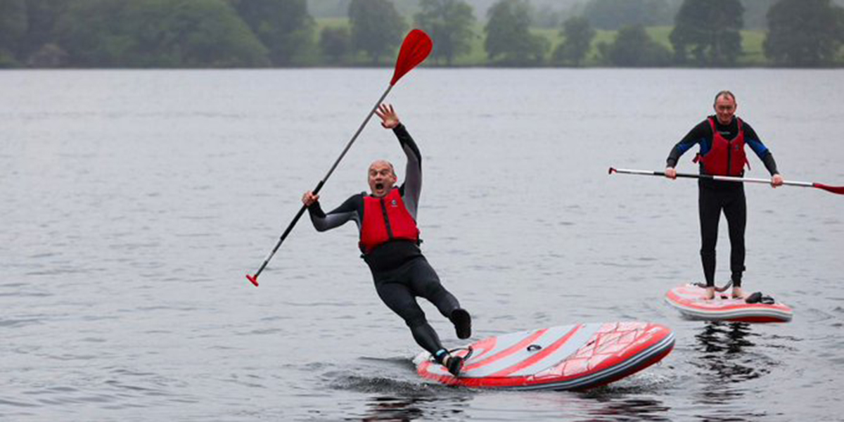 Ed Davey falls off a paddleboard on Lake Windermere.
