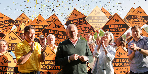 Ed Davey celebrating with Lib Dem MPs at a rally following the local election results