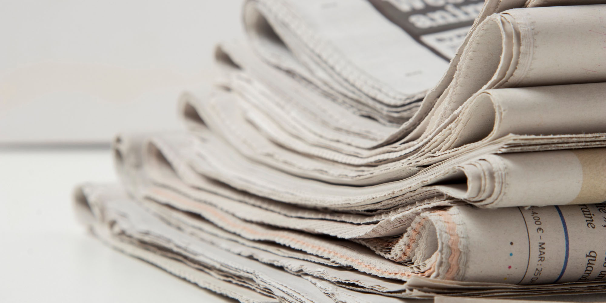 Newspapers stacked up.