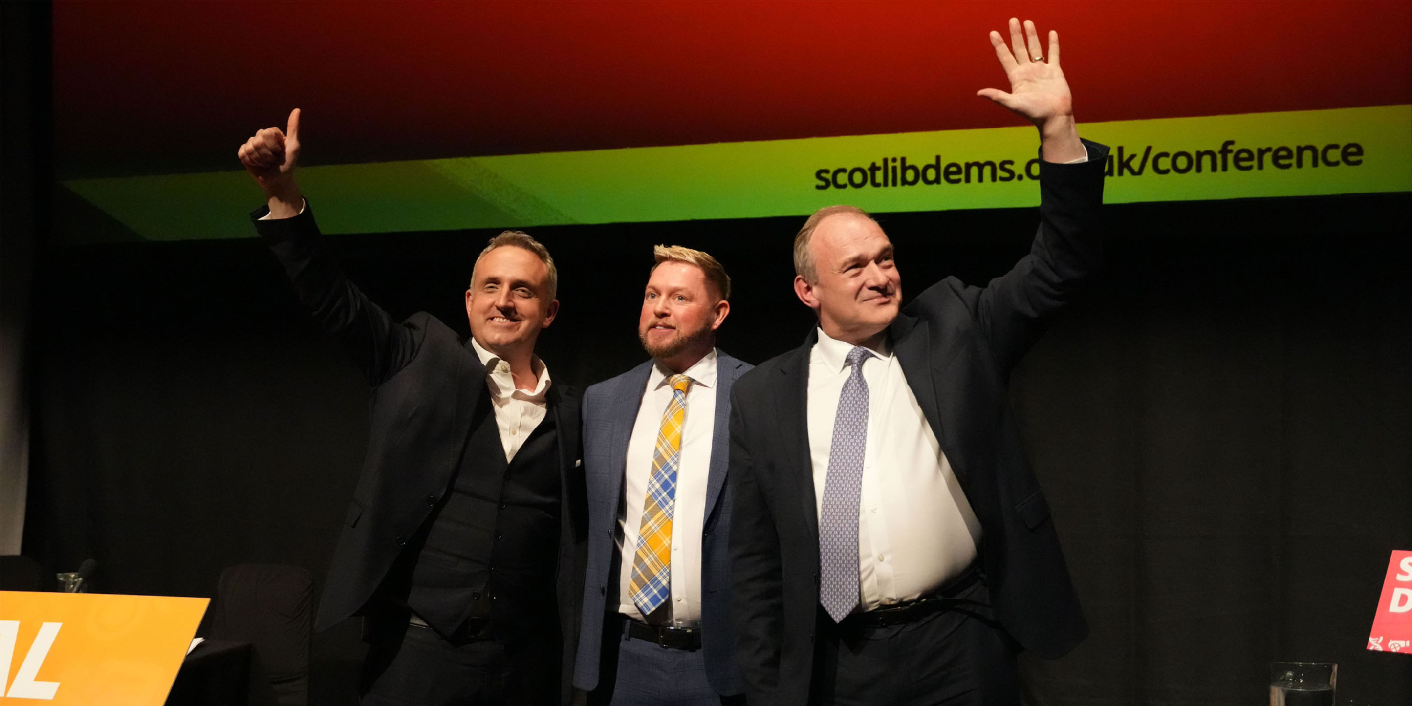 Jamie Greene with Alex Cole-Hamilton and Ed Davey on stage at Scottish Lib Dems Spring Conference.