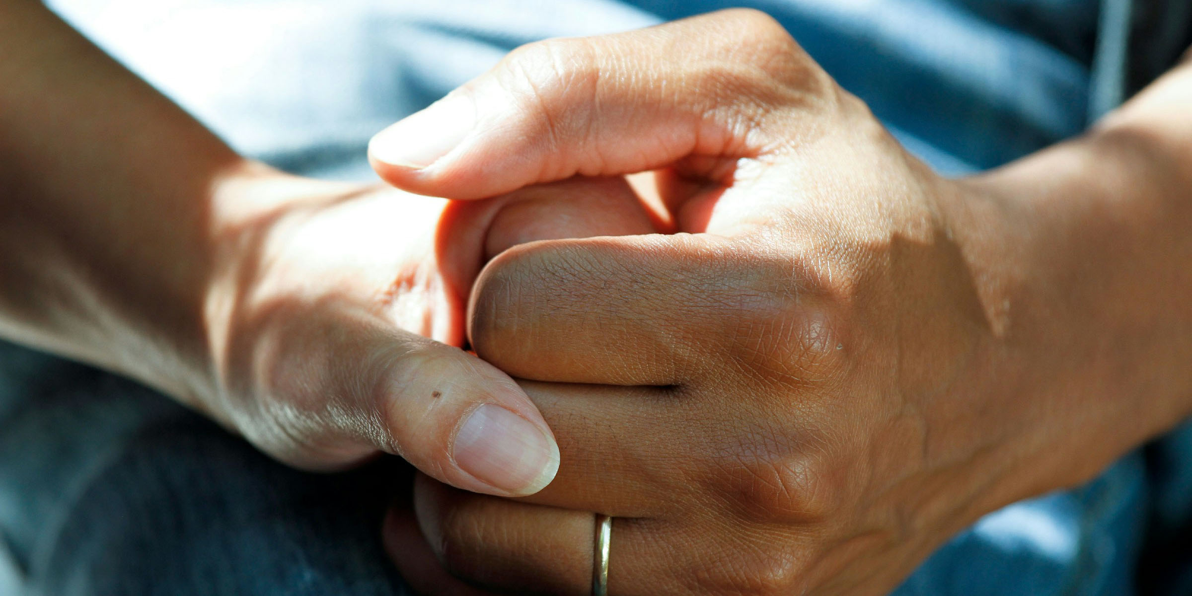 Two hands clasped together