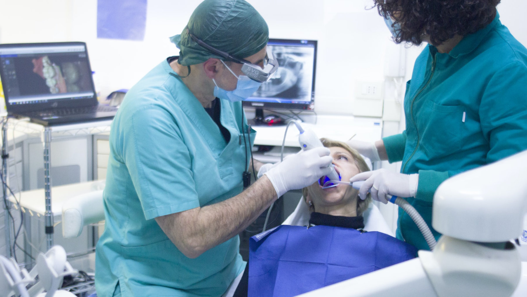 A dentist and dental nurse treat a patient