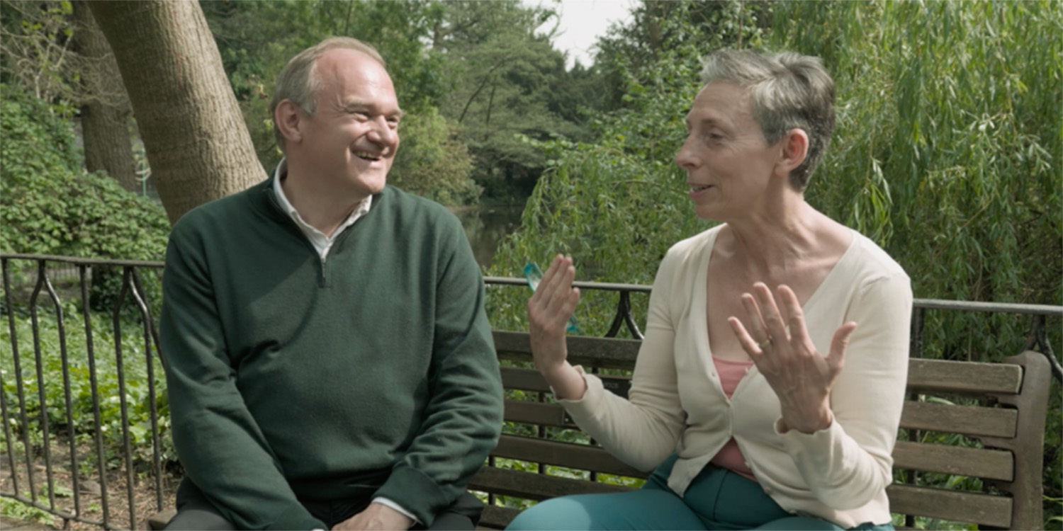 Ed Davey talking on a bench.