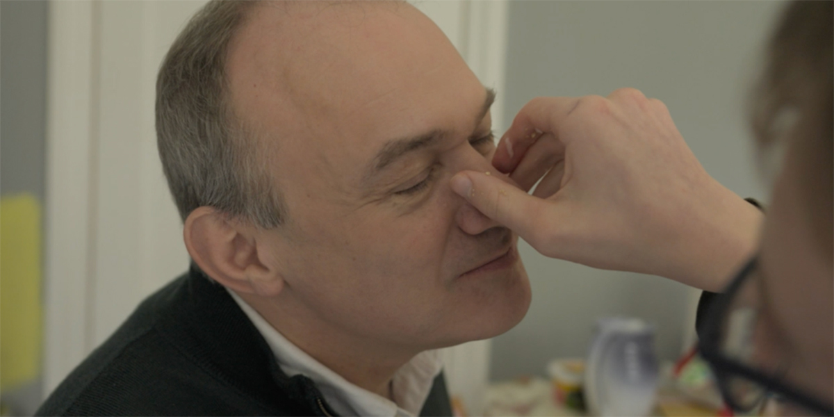 Ed Davey's son pinches his nose.